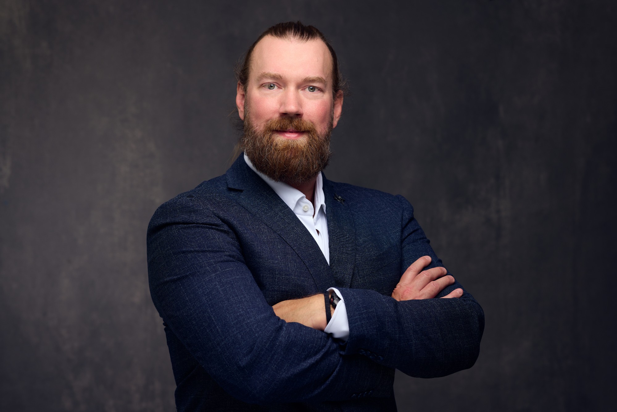 Brandon Wilburn, founder of C9D Consulting, in a navy jacket with arms crossed